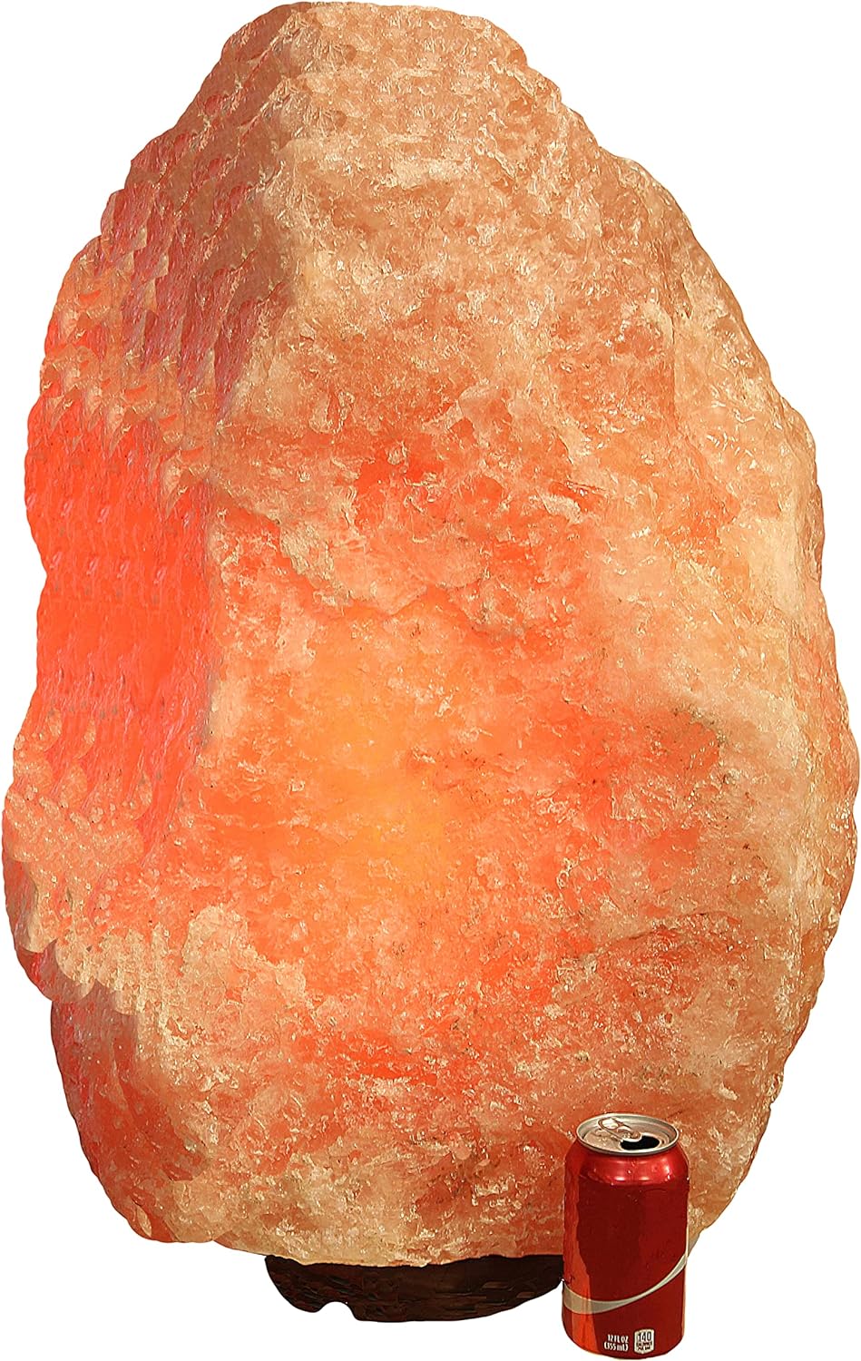 Illuminated large Himalayan salt lamp with soda can.