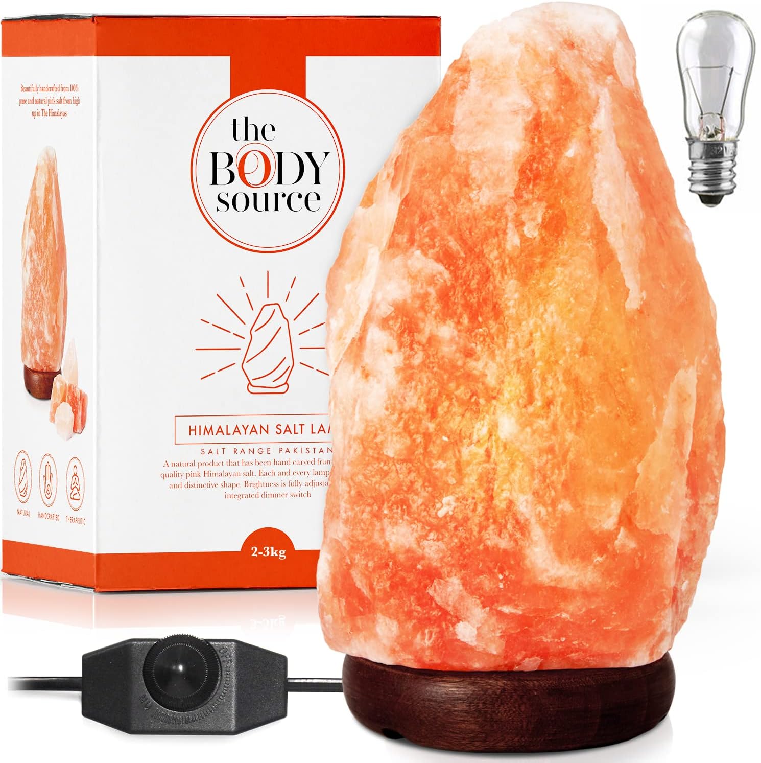 Himalayan salt lamp with dimmer on wooden base.